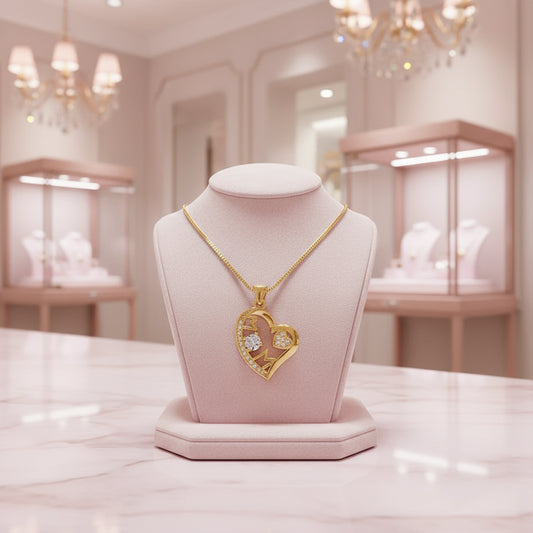Gold heart-shaped pendant with embedded stones on a white background